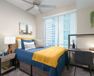 Furnished apartment bedroom with blue and yellow decor